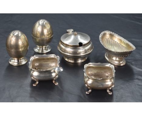 A pair of Victorian silver egg motif pepperettes, raised on circular step moulded feet, marks for Birmingham 1898, indistinct