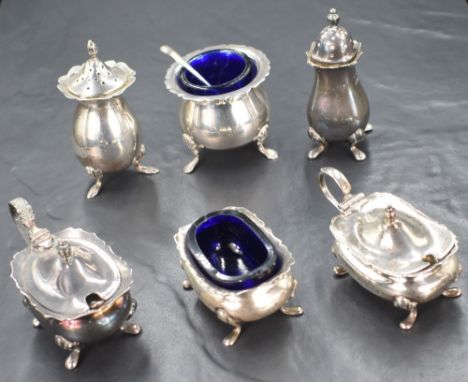 An assortment of six 20th century silver salts, mustards and pepperettes, all having Chippendale style rims raised on cabriol