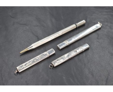Four early 20th century silver mounted pencils, two having decorative engraving and one being mechanical with engine turned d