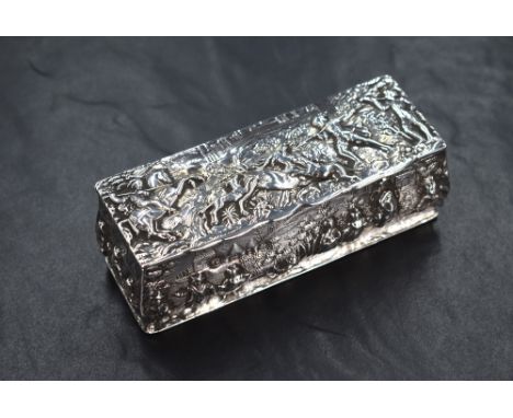 A Victorian silver trinket box, having embossed decoration depicting a hunting scene to the lid with various figures and sett