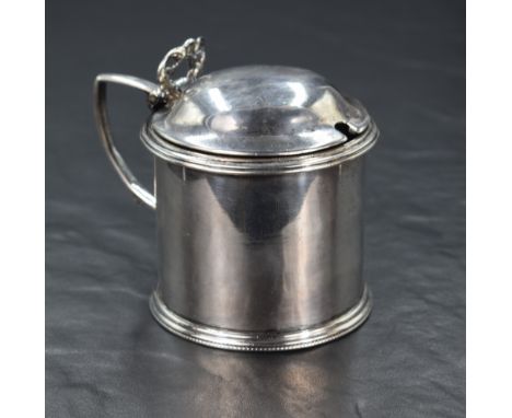 A Victorian silver condiment pot, of circular form having decorative pierced lid opener with angular handle, step moulded rim