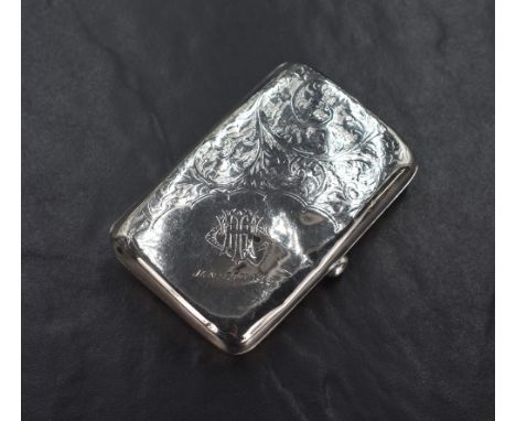 An early George V silver cigarette case of hinged rectangular form, having decorative scroll engraving with a corner engraved