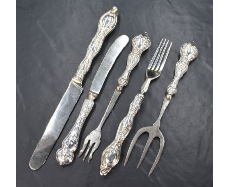 A pair of Victorian silver knife and fork sets, having embossed floral scroll decoration to the handles, marks for London 185