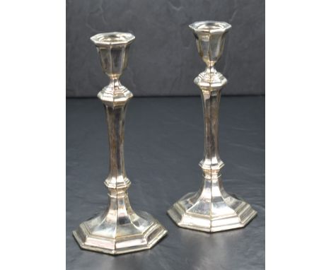 A pair of Elizabeth II silver candlesticks, of turned octagonal form having octagonal scones, raised on knopped columns with 
