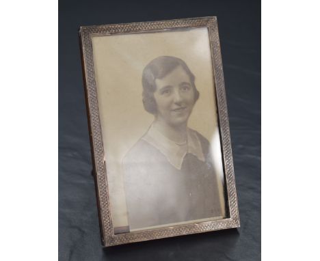 A George V silver mounted wooden photograph frame, of rectangular form having engine turned decoration, marks for Birmingham 