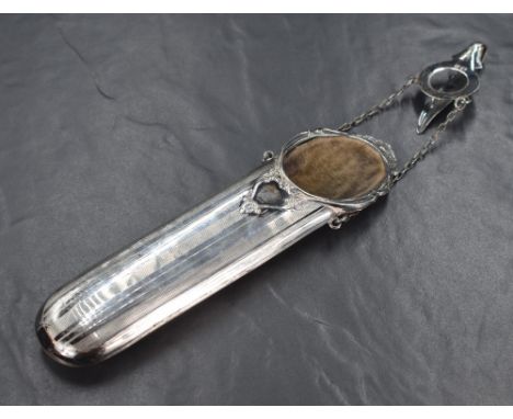 An early George V silver mounted spectacles case, of traditional form having scroll and shell work to the rim and engine turn