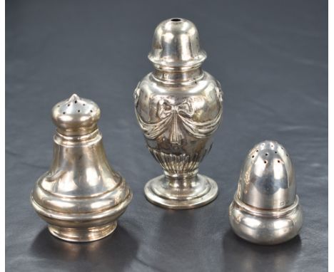 A George V silver salt shaker, having embossed ribbon bow swags and gadrooned base to the body, raised on a circular step mou
