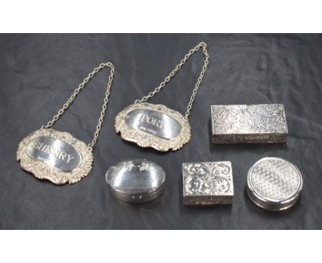 A group of four Elizabeth II silver pill boxes, comprising one of rectangular form having scroll engraving, a square box also