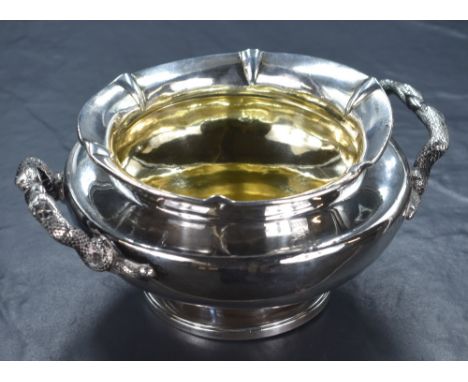 A William IV silver double handled bowl, of circular form having a flared rim with fluted sections, with handles of two snake