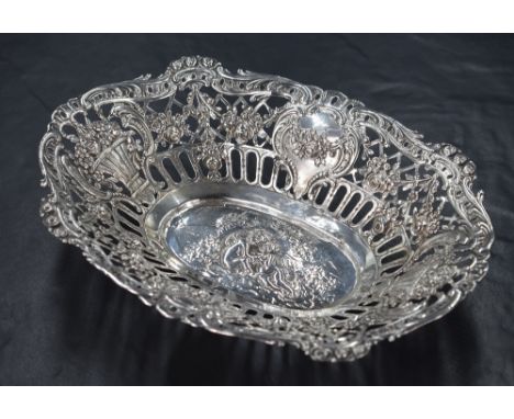 An 800. grade white metal dish, of oval form having ornate pierced sides comprising embossed baskets of flowers, diaper secti