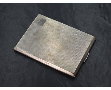 A George VI silver cigarette case of hinged rectangular form, having engine turned decoration and vacant cartouche to the cor