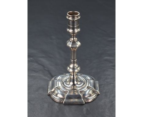 A small George II silver candlestick, having a knopped stem raised on a moulded rounded square foot, marks for London 1740, m