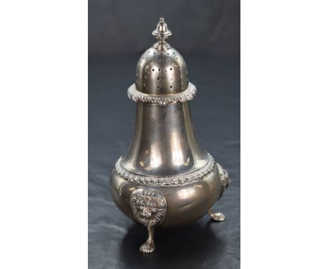 An Elizabeth II silver sugar caster, having a pierced, finial topped cover over the fluted baluster body, with gadrooned styl