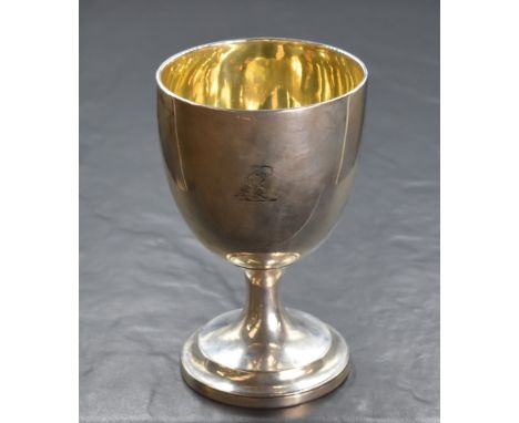 A Victorian silver cup, of traditional form having an engraved heraldic crest to the body, raised on a circular step moulded 