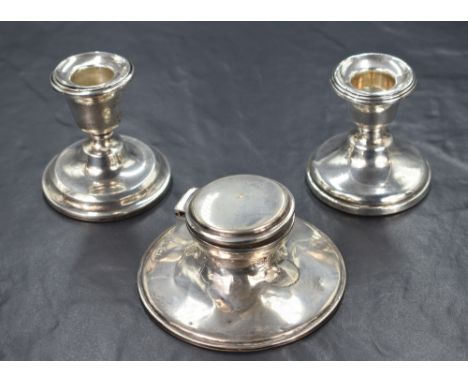 A pair of George V silver stout candlesticks, of traditional form having step moulded sconces, one engraved 'To Brown Owl Fro
