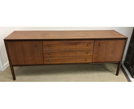 A mid 20th Century Heal's teak sideboard with three central drawers flanked by two cupboard doors, raised on square supports,