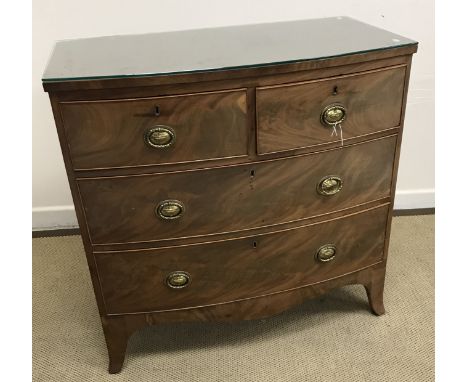 A 19th Century mahogany bow fronted chest of drawers, the plain top above two short and two long drawers with brass ring hand