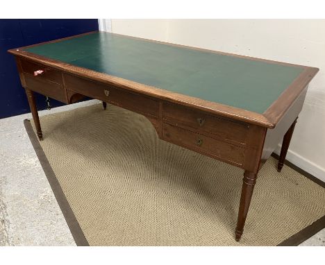 A Continental mahogany writing table in the Empire style the top with writing surface over a central kneehole with drawer fla