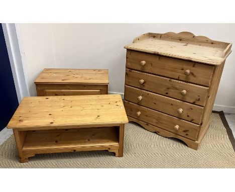 A modern pine dressing chest, the three quarter galleried top over four long drawers with turned knob handles on bracket feet