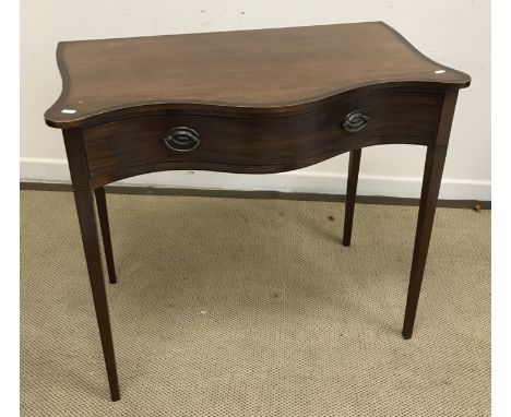 A 19th Century mahogany and inlaid serpentine fronted single drawer side table, the inlaid top above single drawer, raised on