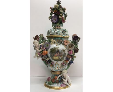 A 19th Century Meissen pot pourri vase with all over high relief fruit and floral encrusted decoration with cherubs and putti