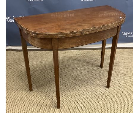 A 19th Century mahogany bow fronted foldover tea table, the top crossbanded and satinwood strung over a plain frieze on squar