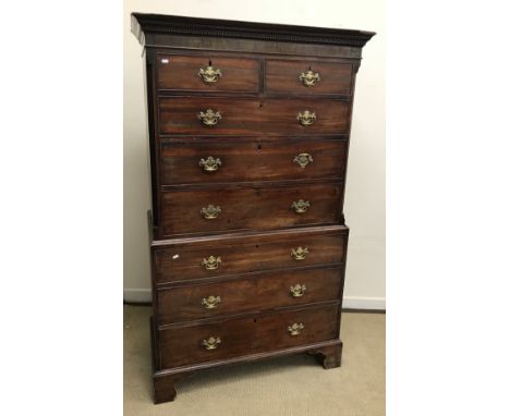 A late George III mahogany chest on chest, the moulded and Greek key type decorated cornice over a plain frieze and two short
