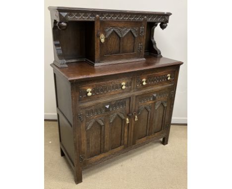 A mid 20th Century oak court cupboard in the 17th Century style, the upper section with central cupboard door over two drawer