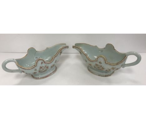 A pair of late 18th/early 19th Century Chinese porcelain sauceboats of inverted helmet form, the main bodies decorated with f