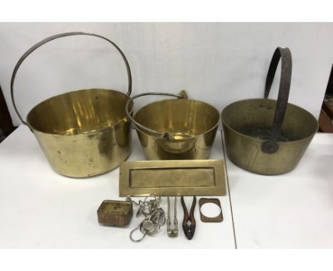 A collection of various copper and brass ware to include three iron-handled brass jam pans, iron oval cauldron, copper and br