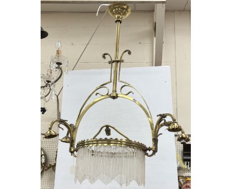 An Arts & Crafts brass light fitting with glass decoration approx. 104 cm long including glass drops