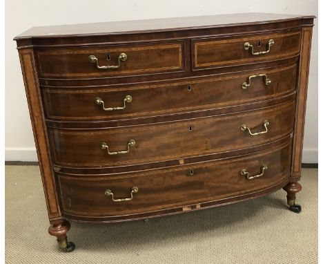 An early 19th Century mahogany bow fronted chest, the top cross banded satinwood strung and with moulded edge over a shallow 