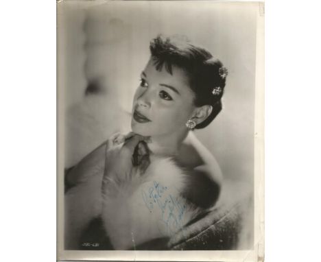 Judy Garland signed 10x8 sepia vintage photo. Couple of knocks and tape marks to border of photo but not affecting the actual