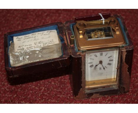 A BRASS CARRIAGE CLOCK retailed by Asprey, Bond Street, London with white enamel dial and Roman numerals and outer leather ca