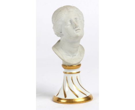 A SMALL CLASSICAL BISQUE PORCELAIN BUST of Venus on a gilded ceramic base with underglaze blue mark, 11cm high