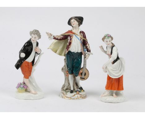 A CONTINENTAL PORCELAIN FIGURE of a mandolin player with polychrome enamel decoration, 23cm high and a pair of 19th Century c