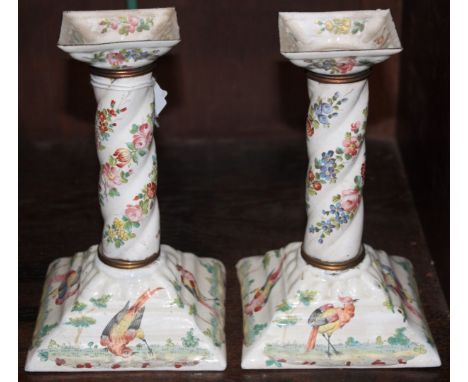 A PAIR OF ANTIQUE ENAMEL CANDLESTICKS of spiral column form with painted oriental pheasant and trailing flower decoration, 17
