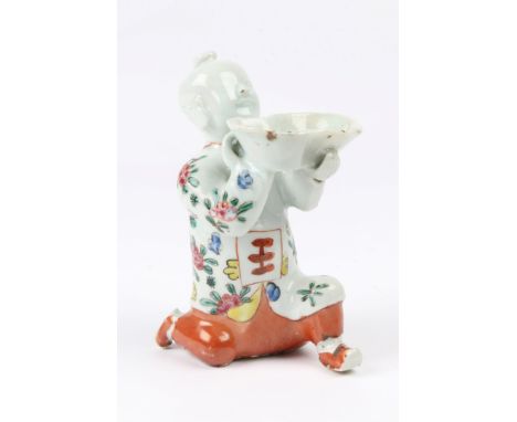 A JAPANESE PORCELAIN FIGURE of a boy kneeling with a bowl with polychrome enamel decoration, 16cm high