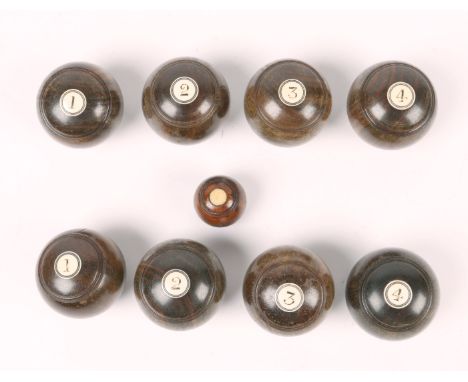 A SET OF EIGHT LIGNUM VITAE INDOOR BOWLS with bone inset numerals with jack (9)