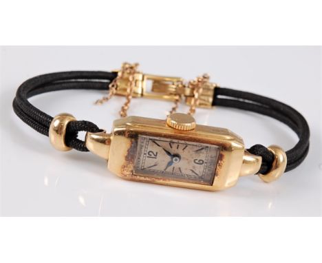 A lady's c.1930's 18ct Patek Philippe wristwatch, the tank style watch with cream dial, black Arabic and baton numerals, hand