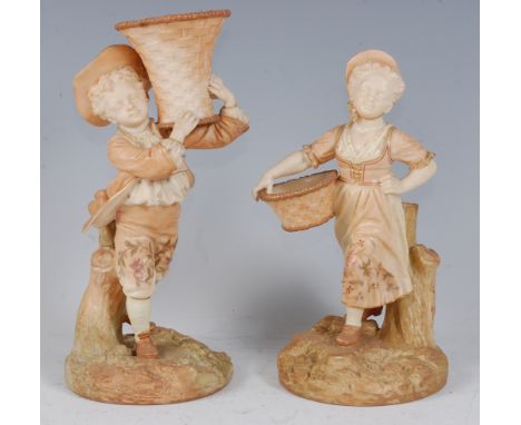 *A pair of Royal Worcester blush ivory figures, the boy in standing pose with a basket upon his shoulder, on a naturalistic b