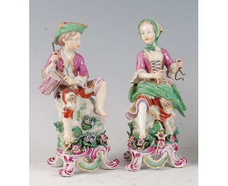 A pair of 18th century English soft-paste porcelain musician figures, as a drummer-boy and girl playing a triangle, each on f