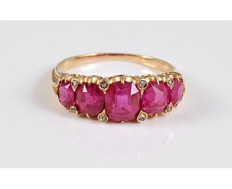 A five stone ruby ring, the five graduated cushion cut rubies, between approx. 4.1 - 5.8mm wide, set with diamond highlights,