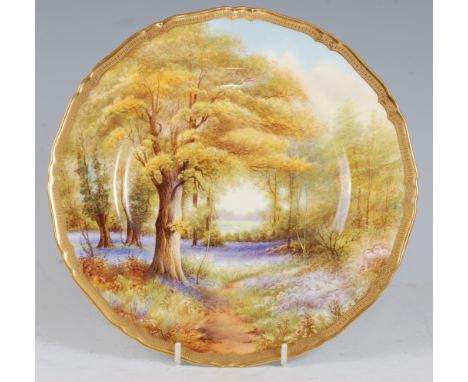 *A Royal Worcester porcelain cabinet plate, hand-painted with bluebells in Kew Gardens by Raymond Rushton, within shaped gilt