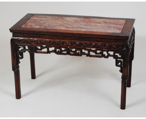 A 19th century Chinese rosewood occasional table, having marble inset top and blind carved frieze on turned and square back s