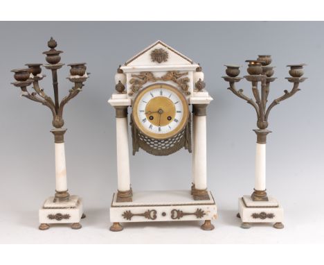 A French Empire period white marble and gilt metal mounted three piece clock garniture, as a portico clock having indistinctl