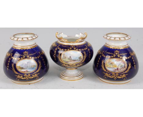 *A Royal Crown Derby three vase garniture, each piece having a central panel painted with a landscape and signed W. E. J. Dea