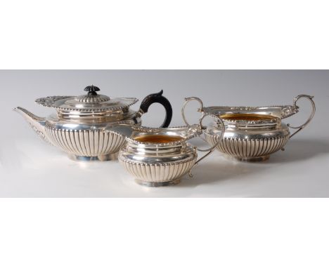 A well-matched Victorian silver three-piece tea set, comprising teapot, twin handled sugar and creamer, the teapot of squat c