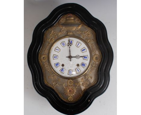 A late 19th century French comtoise wall clock, the shaped ebonised case enclosing a white enamel dial with raised Roman nume
