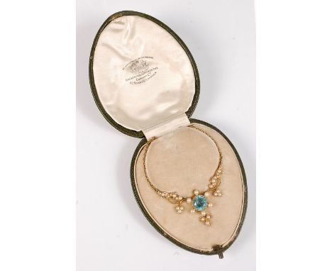 *An Edwardian zircon and pearl pendant, the round blue zircon, in collet mount with milligrain border, approx. 9.5mm diameter